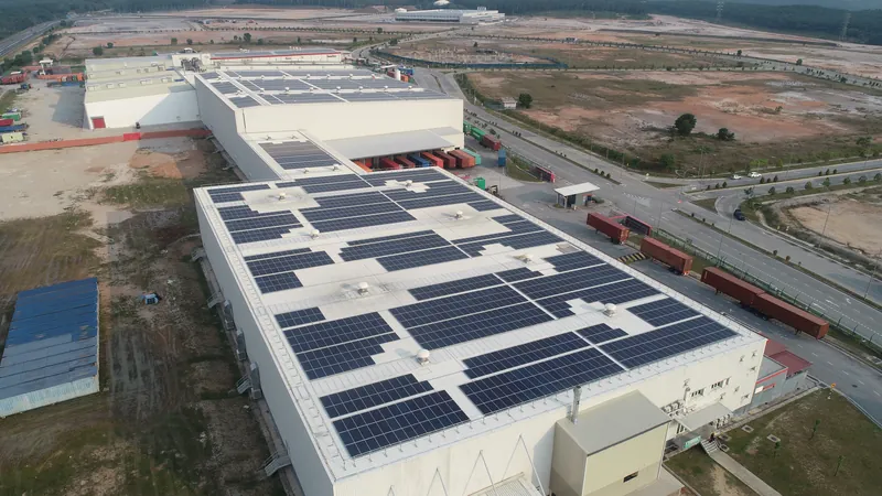 Aerial view of rooftop solar on a food manufacturing plant beside a river (view 1)