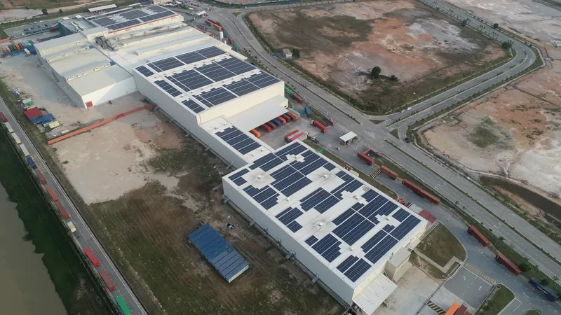 Aerial view of rooftop solar on a food manufacturing plant beside a river