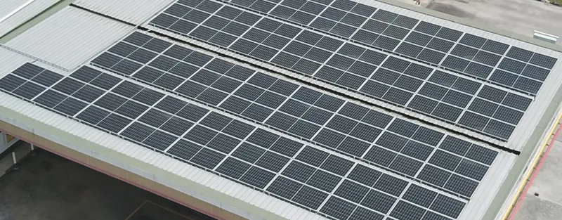 Solar panels on a fuel-station canopy roof, seen from above