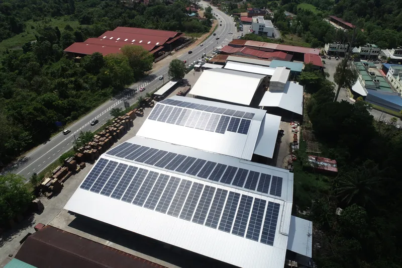 Aerial view of rooftop solar on a timber sawmill with stacked timber